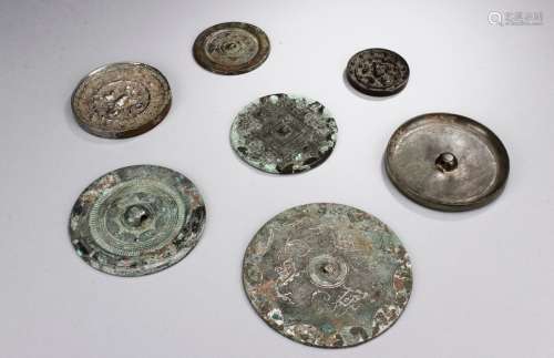 A GROUP OF SEVEN BRONZE MIRRORS