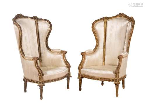 A pair of carved giltwood and upholstered armchairs in Louis...