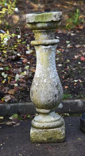 A carved limestone baluster plinth