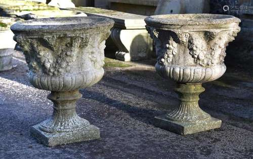 A pair of stone composition garden urns