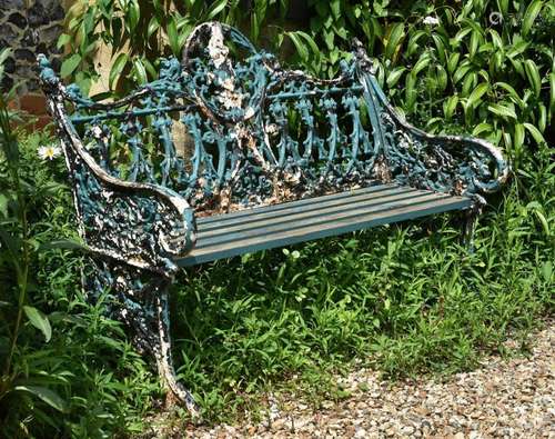 A green painted cast iron bench in the Coalbrookdale 'Go...