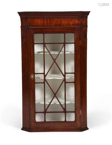 A George III mahogany hanging corner cabinet