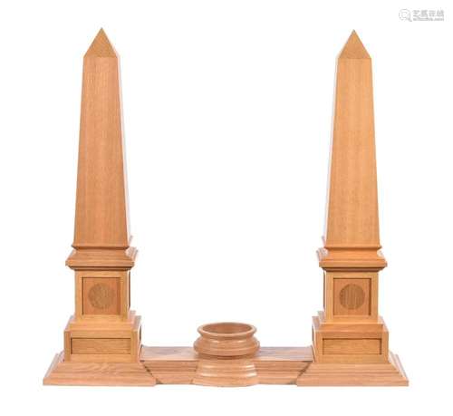 A pair of oak obelisks with stand