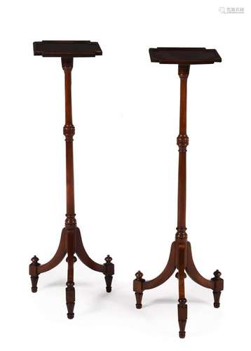 A pair of mahogany torcheres