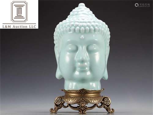 A Chinese Celadon Glazed Porcelain Buddha Head