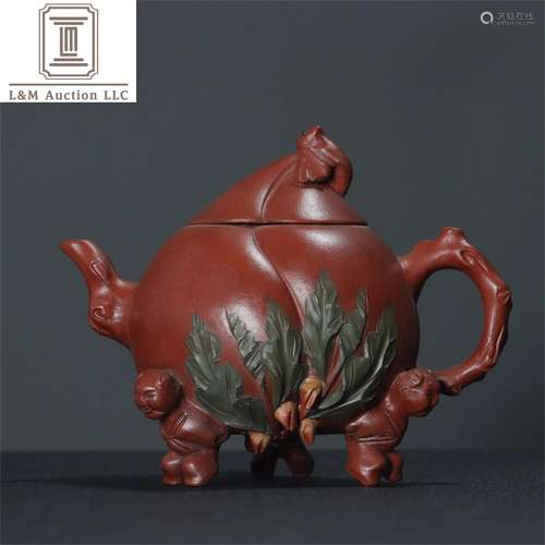 A Chinese Yixing Zisha Peach Patterned Teapot