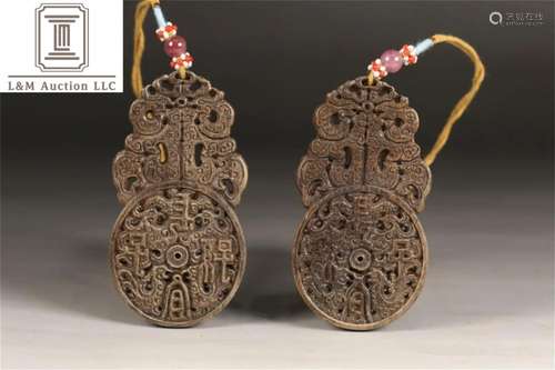 A Pair of Carved Agarwood Pendants