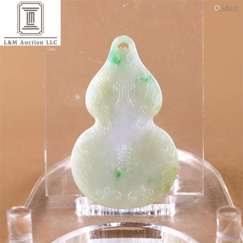 A Chinese Carved Jadeite Gourd Pendant