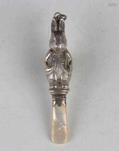 A George V silver childs rattle in the form of Beatrix Potte...