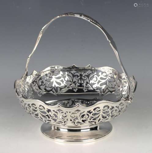 A George V silver circular swing handled basket, the wavy ri...
