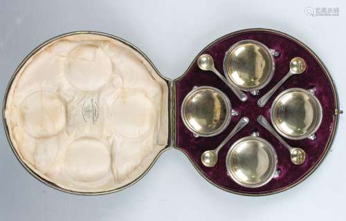 A set of four Edwardian silver circular salts, each with a b...