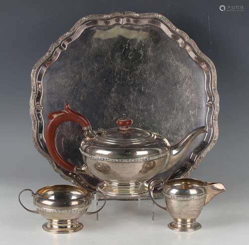 An Elizabeth II silver three-piece tea set of squat circular...