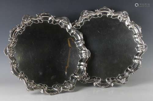 A pair of George V silver circular salvers, each with raised...