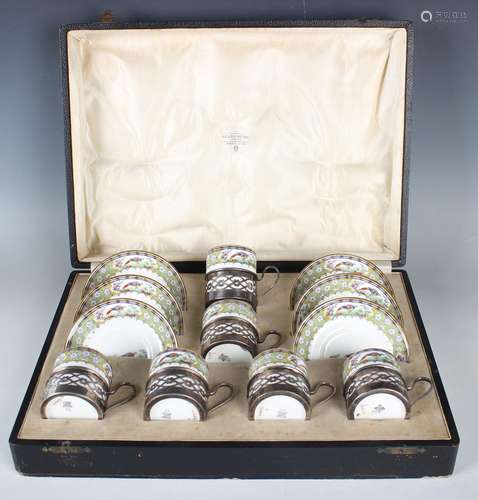 A set of six George V silver coffee can holders, each with p...