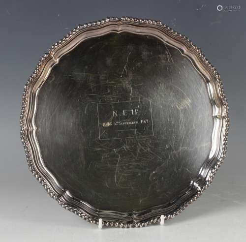 An Elizabeth II silver circular card salver with inscription...