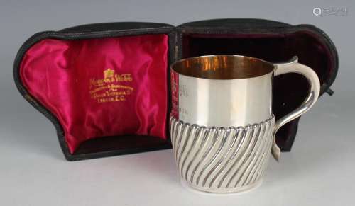 A late Victorian silver christening mug of half spiral reede...