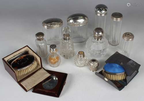 A group of silver lidded cut glass dressing table bottles, i...