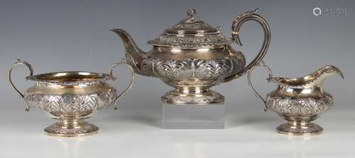 A George IV silver three-piece tea set, each piece repousse ...