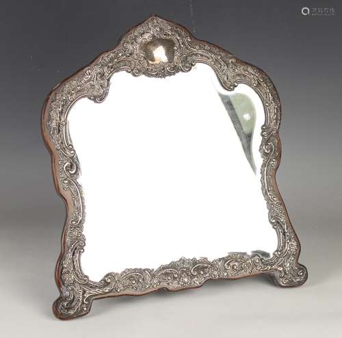 An Edwardian silver mounted dressing table mirror of arched ...