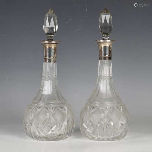 A pair of George V cut glass decanters with silver collars, ...