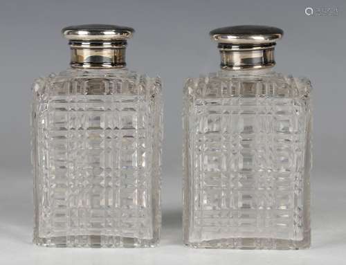 A pair of Victorian square cut glass perfume bottles and sto...