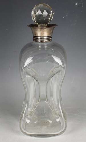 An Edwardian clear glass cluck-cluck decanter with silver co...