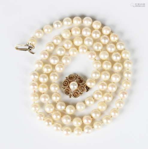 A single row necklace of uniform cultured pearls on a 9ct go...