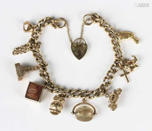 A 9ct gold curblink charm bracelet on a 9ct gold heart shape...