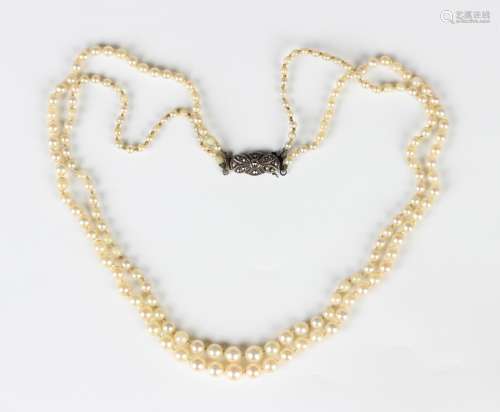 A two row necklace of graduated cultured pearls on a silver ...
