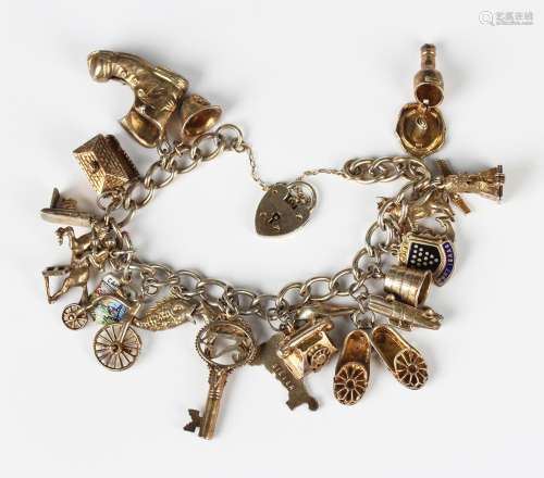 A silver gilt curblink charm bracelet, fitted with a variety...