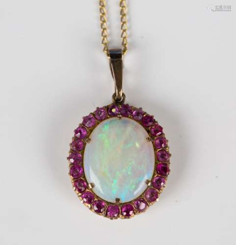 A gold, opal and ruby oval cluster pendant, claw set with th...