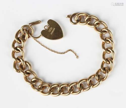 A 9ct gold solid curblink bracelet on a 9ct gold heart shape...