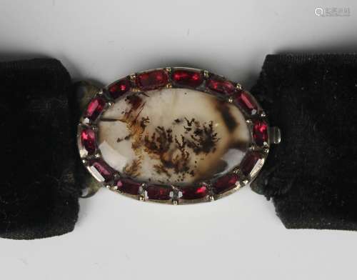 A moss agate and foil backed garnet set oval clasp, probably...