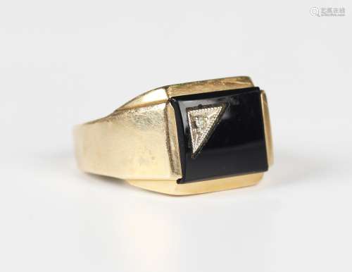 A gold, black onyx and diamond rectangular signet style ring...
