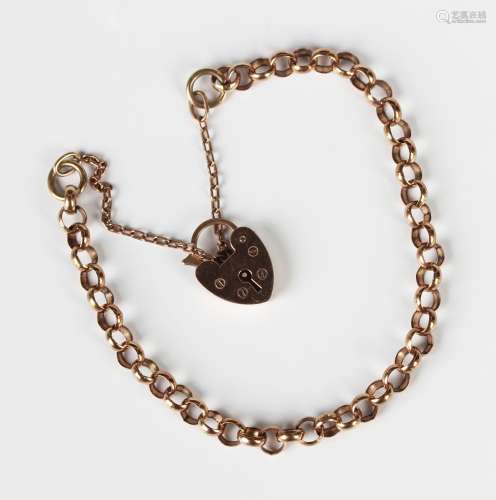 A gold circular link bracelet on a gold heart shaped padlock...