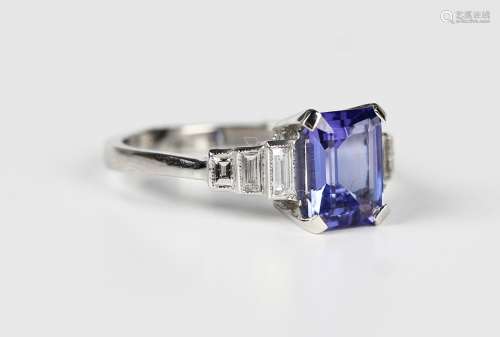 A platinum, tanzanite and diamond ring, claw set with the cu...