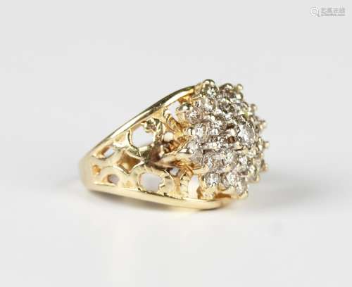 A 14ct gold and diamond cluster ring in a tiered design, mou...