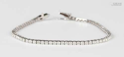A white gold and diamond bracelet, mounted with a row of cir...