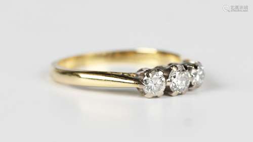 An 18ct gold and diamond three stone ring, claw set with a r...