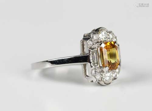 A platinum, treated yellow sapphire and diamond cluster ring...