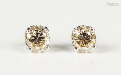 A pair of white gold and diamond single stone earstuds, each...
