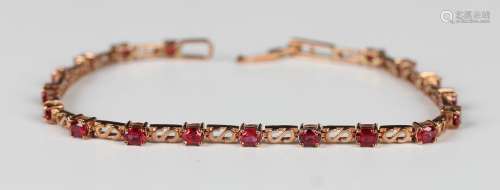 A gold and ruby bracelet, claw set with circular cut rubies ...