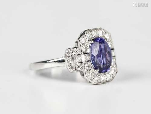 A white gold, tanzanite and diamond cluster ring, claw set w...