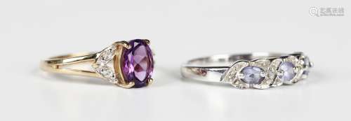 A 9ct gold ring, claw set with an oval cut amethyst between ...