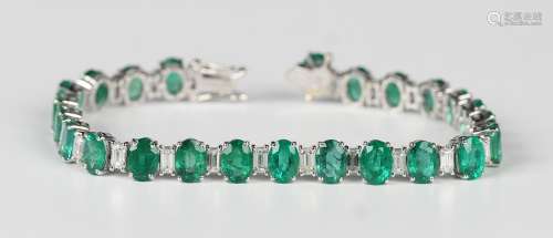 A white gold, emerald and diamond bracelet, claw set with a ...
