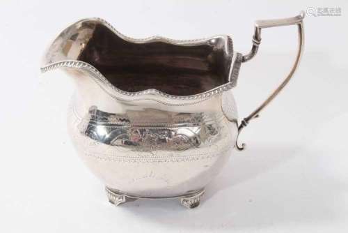 George III Irish silver milk jug with floral engraved decora...