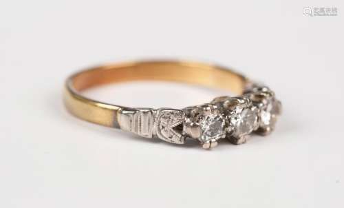 An 18ct gold and diamond three stone ring, mounted with a ro...