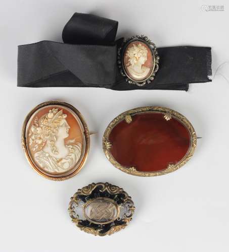 A Victorian gold mounted oval shell cameo brooch, carved as ...