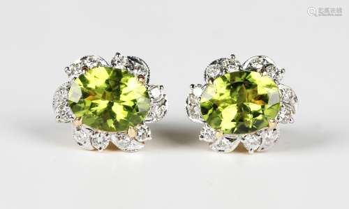A pair of gold, peridot and diamond cluster earstuds in a fl...