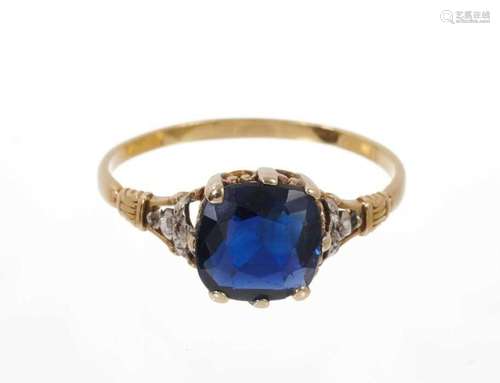 Sapphire and diamond ring with a cushion cut blue sapphire